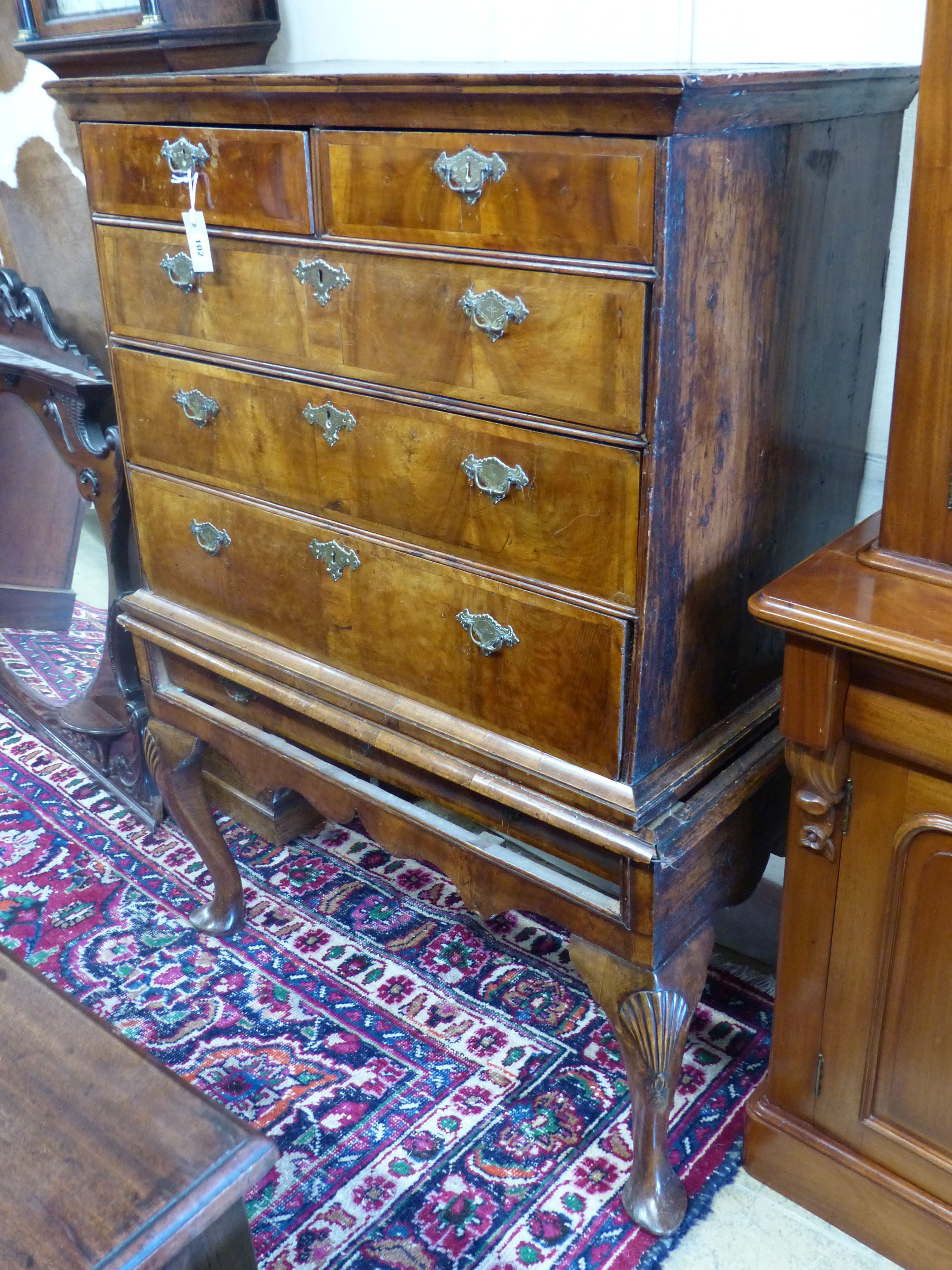 An early 18th century walnut and pine sided chest on stand, width 101cm, depth 58cm, height 138cm